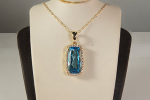 Blue Topaz and Diamond Halo Pendant
