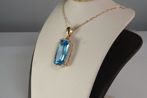 Blue Topaz and Diamond Halo Pendant